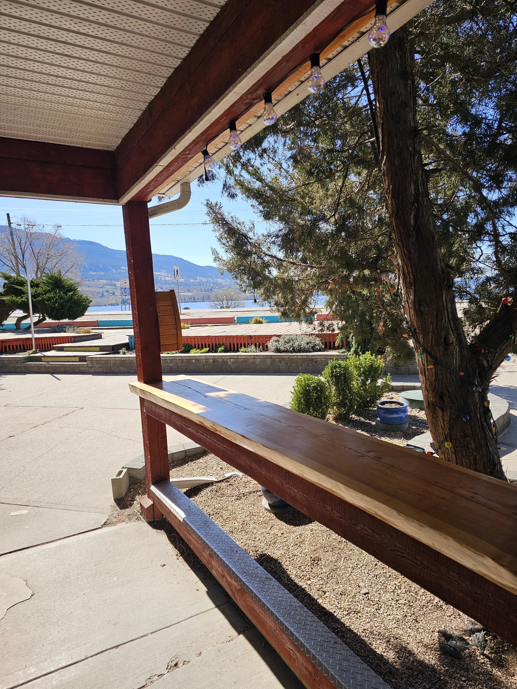Covered porch bench looking out over Wood Lake and the surrounding Okanagan hills