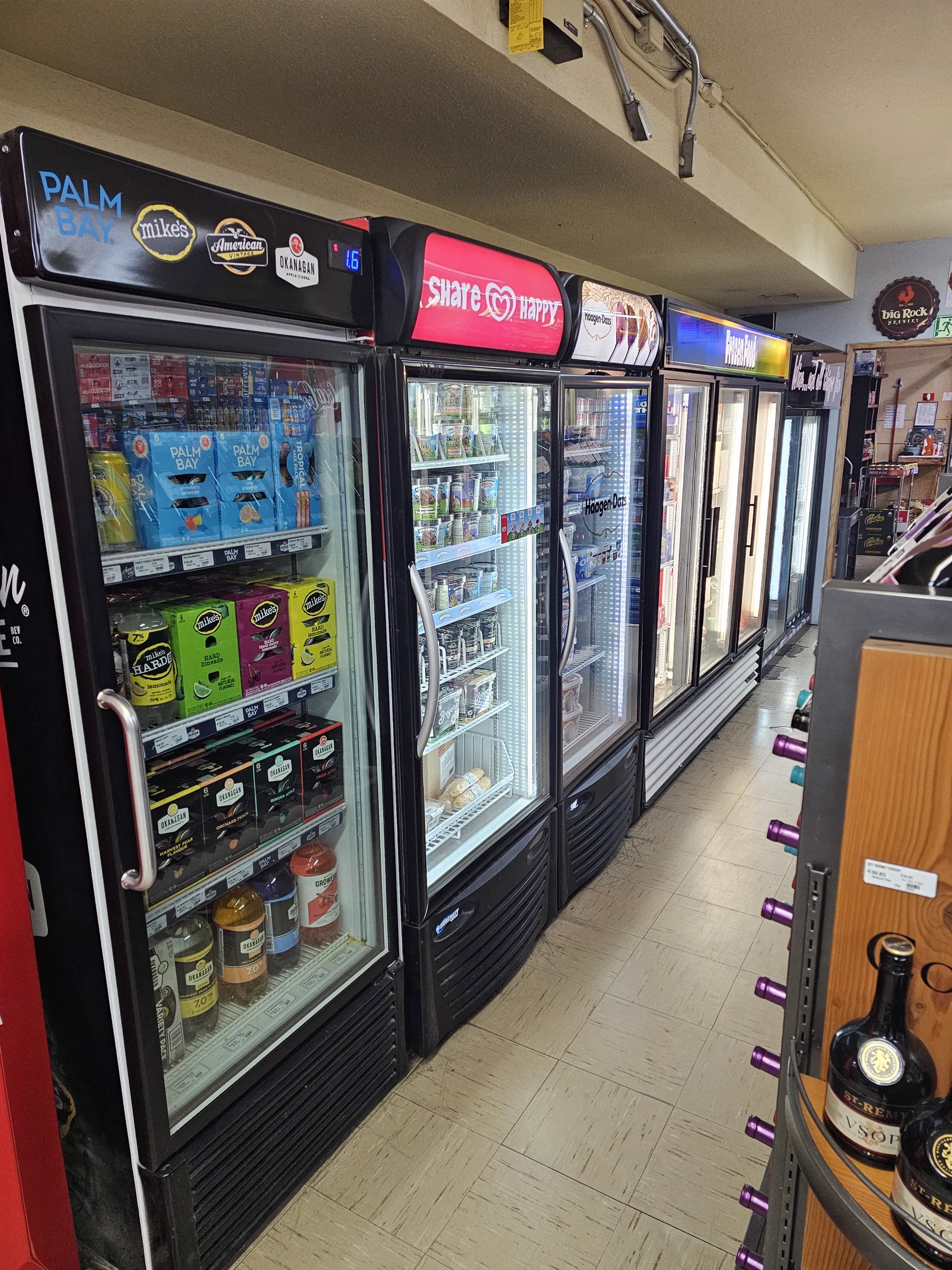Glass-door coolers stocked with chilled drinks and coolers inside the store