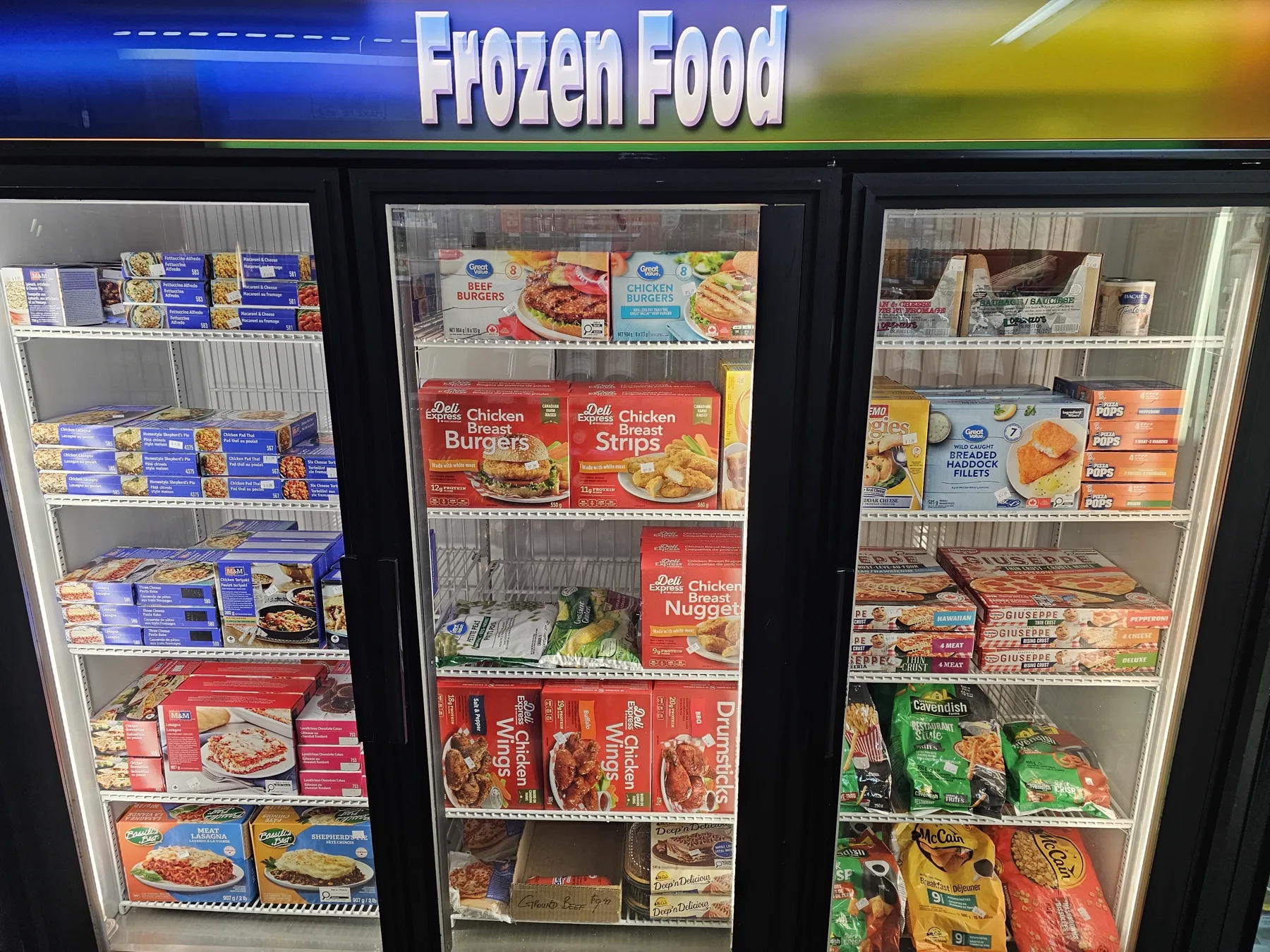 Frozen food freezers stocked with packaged meals and chicken