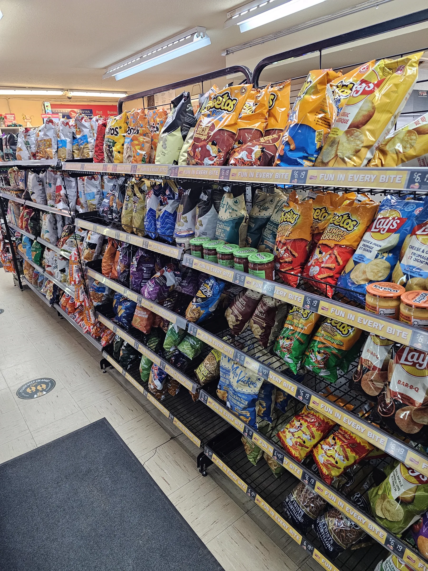 Chip and snack aisle lined with bags of Lay's, Doritos and other snacks