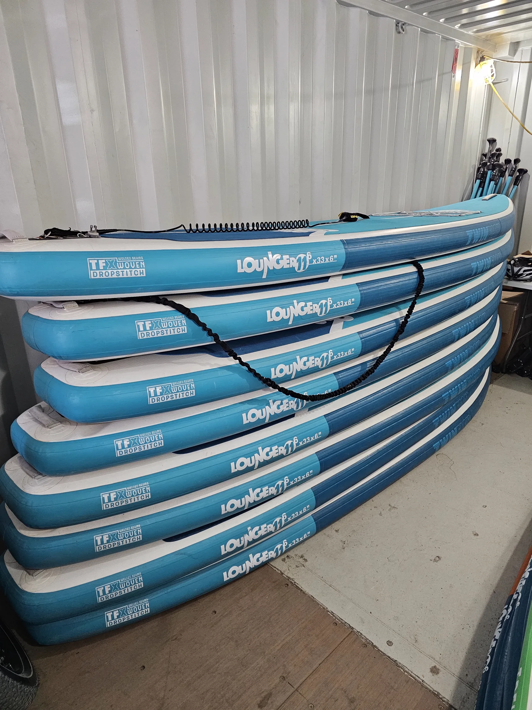 Stack of inflatable Tower lounger paddleboards in the rental container