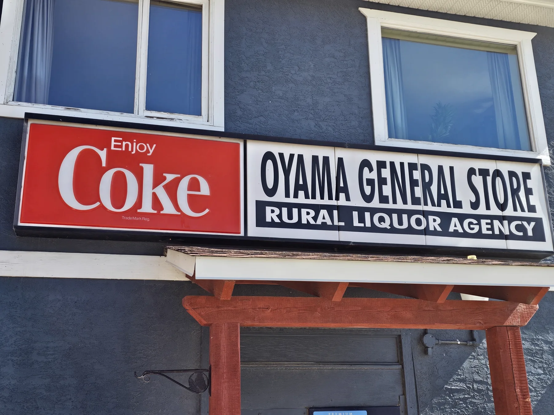 The Oyama General Store storefront sign with the vintage Coke sign